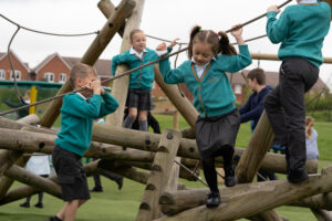 A group of children playing on playground equipment